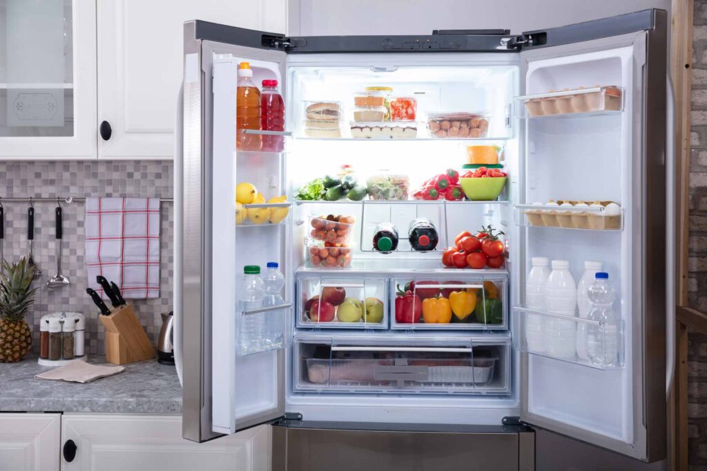 Happy customer storing food in freezer after professional repair